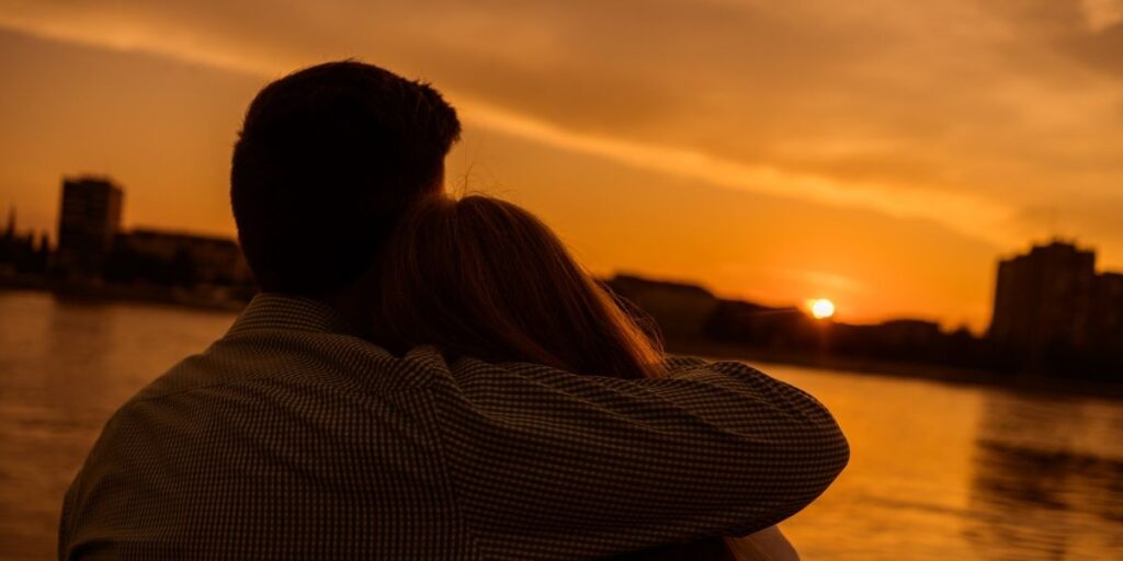 Couple hugging at sunset